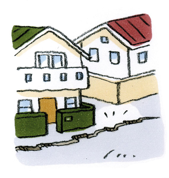 住宅街の道路に亀裂ができているイラスト。